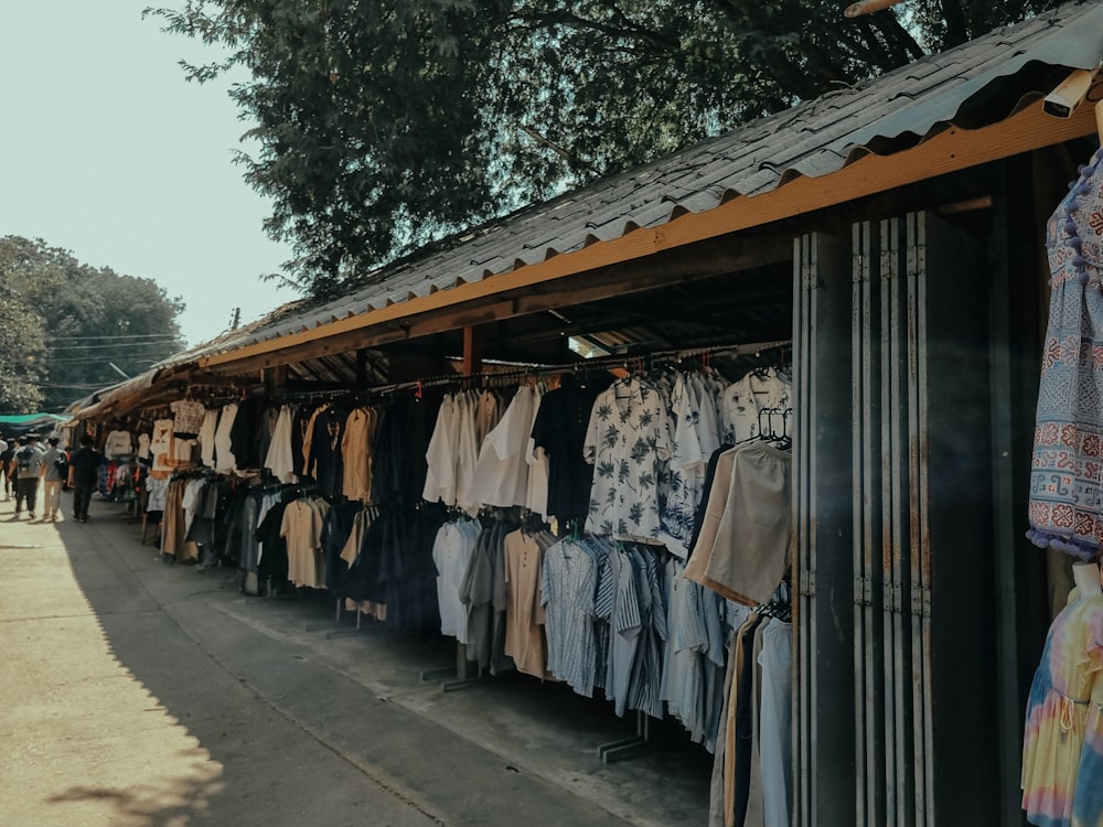 a row of clothes hanging on a line next to a building