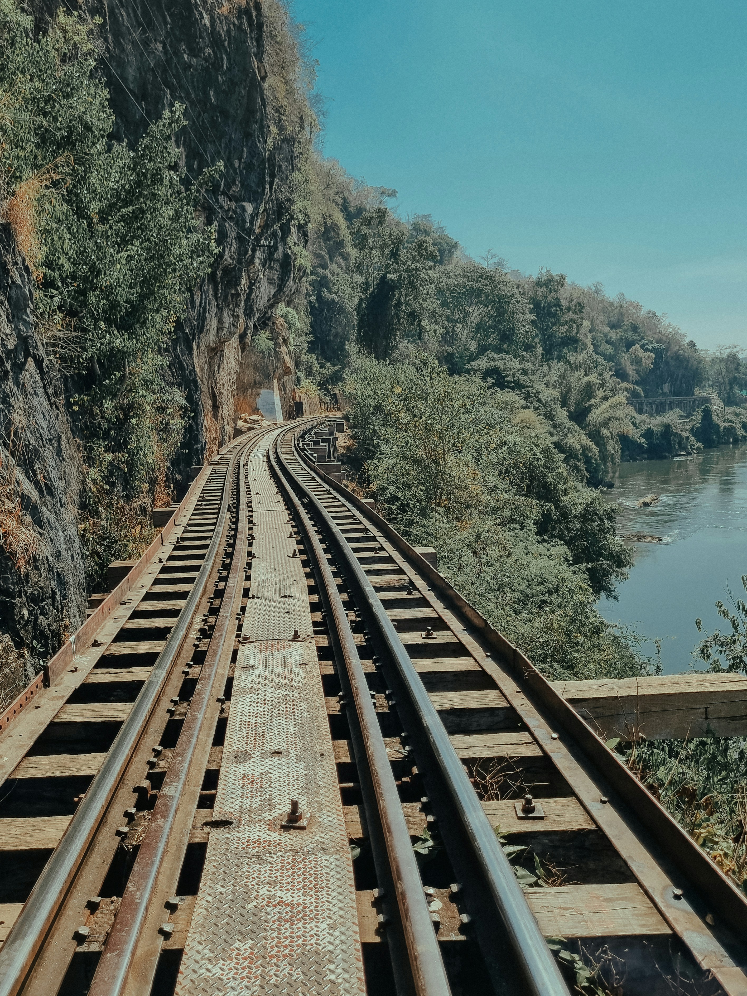 a view of a train track next to a river