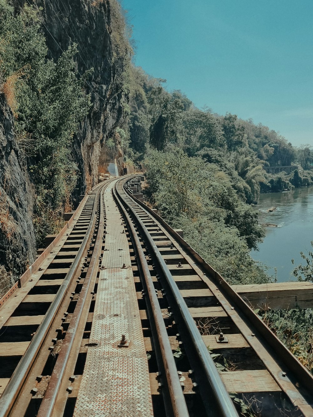 a view of a train track next to a river