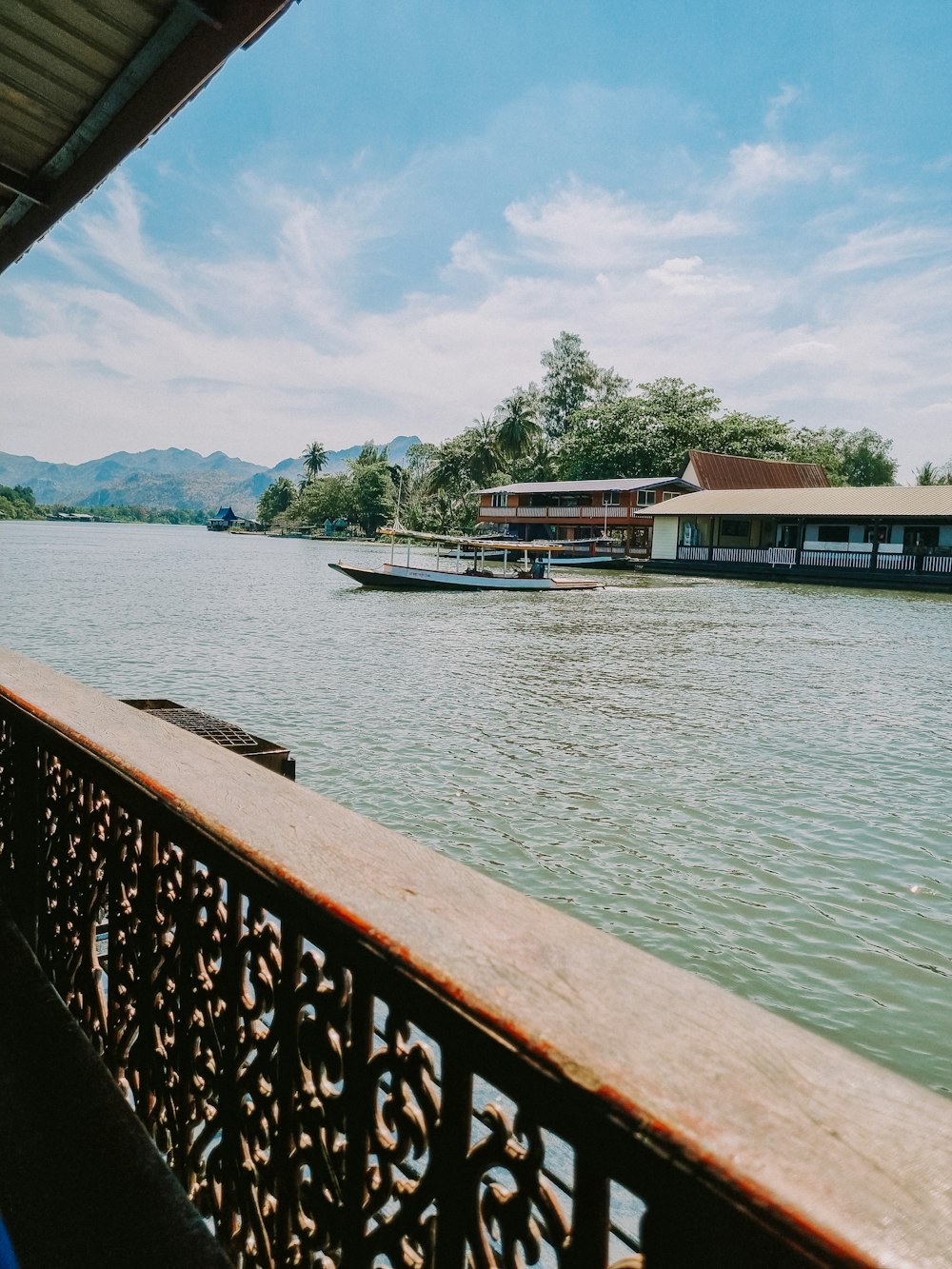 a boat traveling down a river next to a building