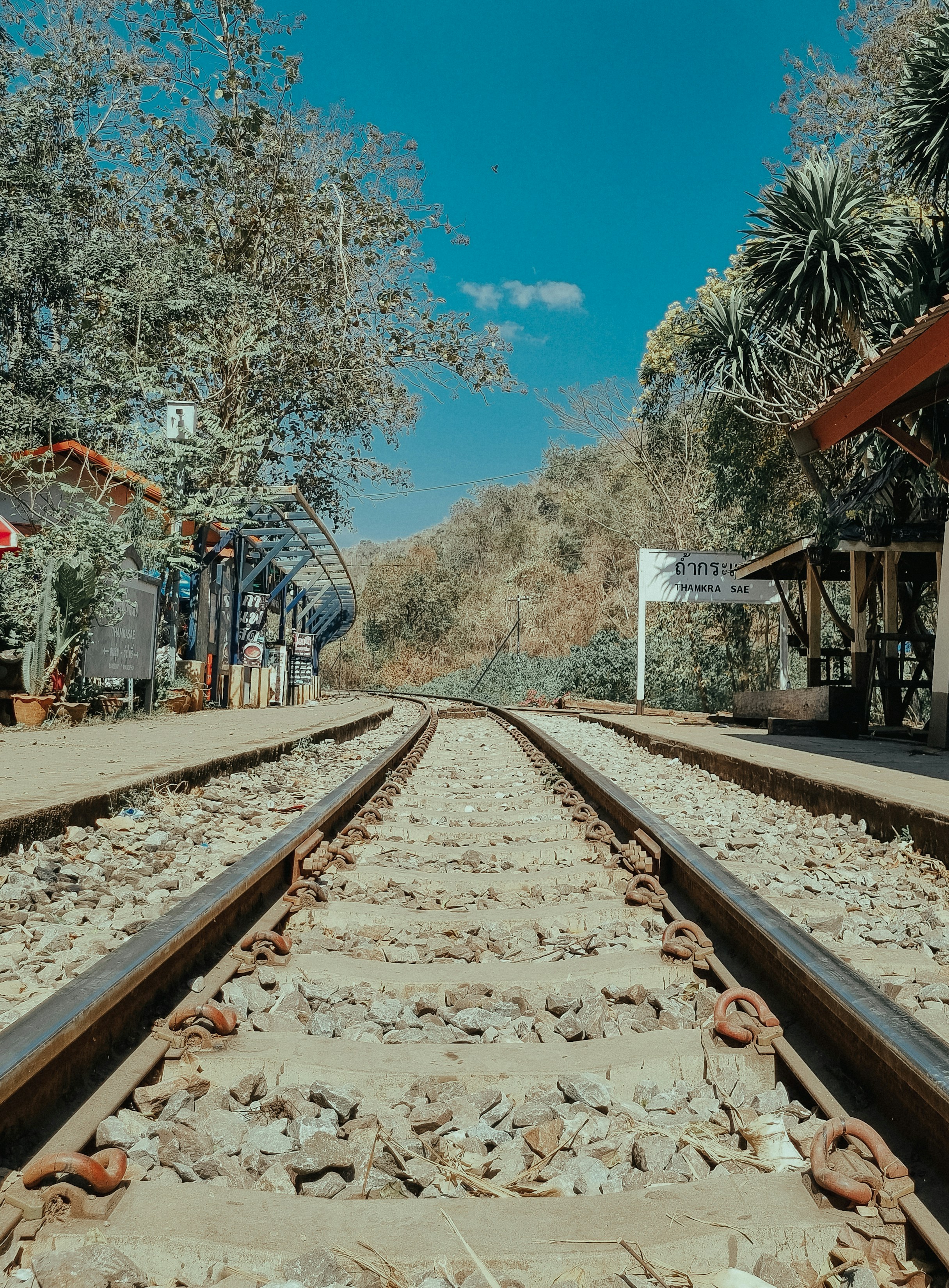 a view of a train track with trees in the background