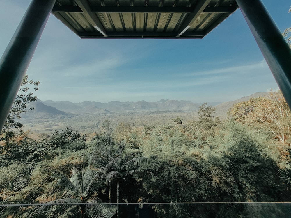a view of the mountains and trees from inside a building