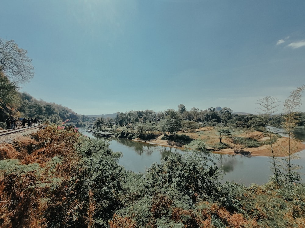 a view of a river and a train on the tracks