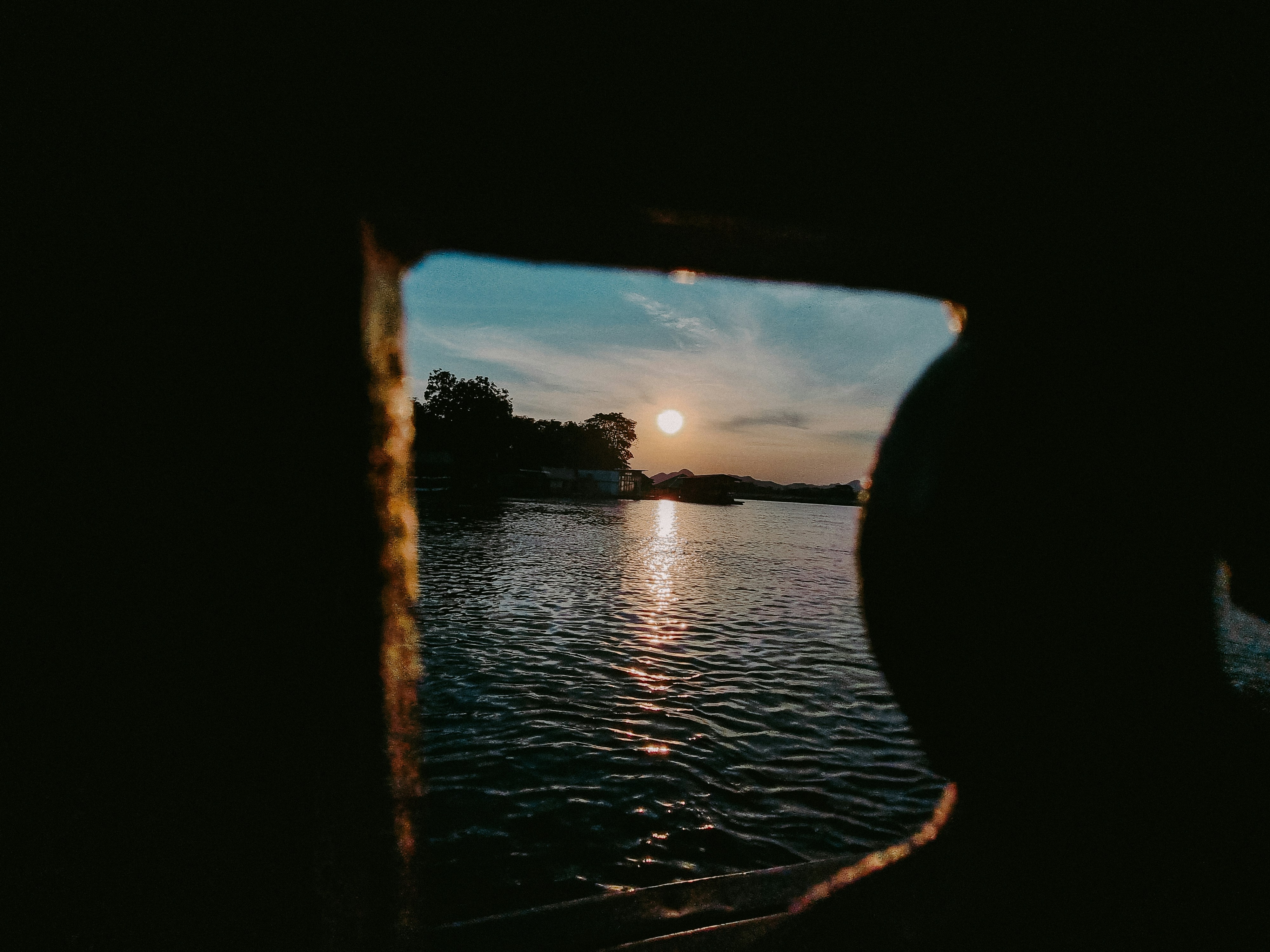 the sun is setting over a body of water