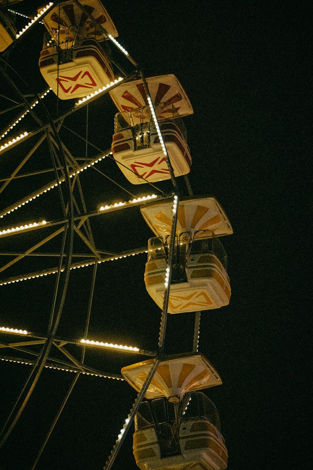 a ferris wheel lit up at night with lights