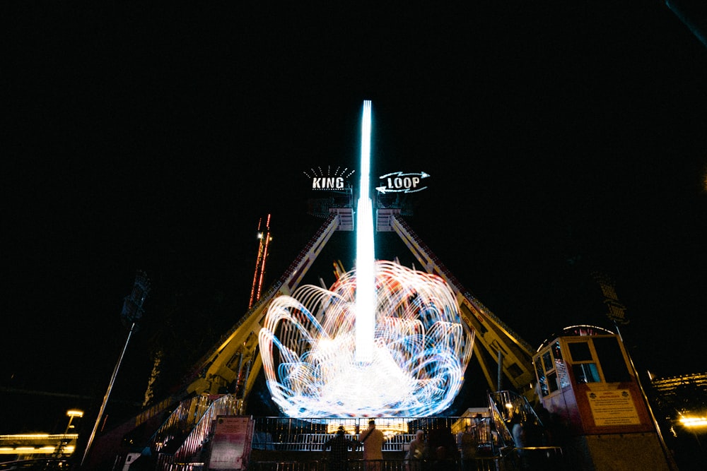 a carnival ride at night with a light show