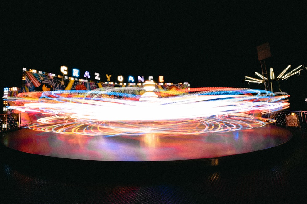 a blurry photo of a carnival ride at night