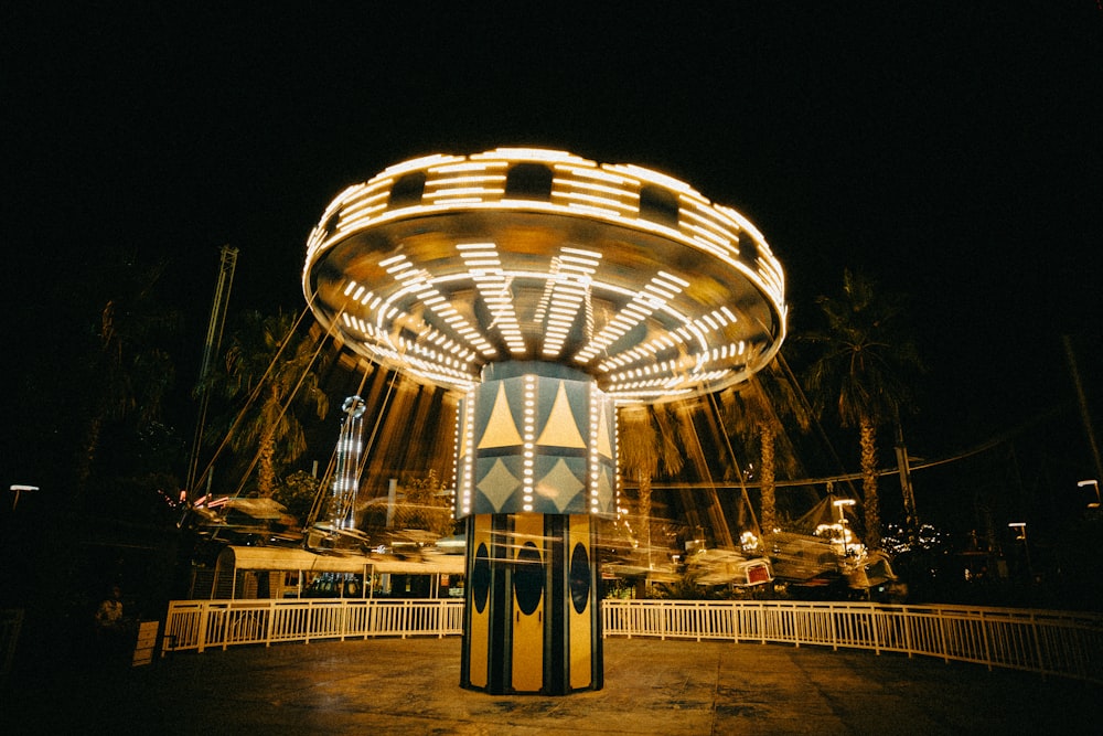 a merry go round at night with lights on