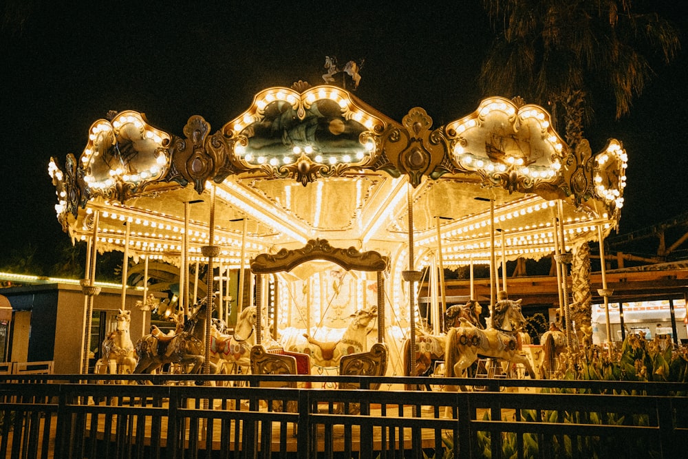 a merry go round at night with lights on