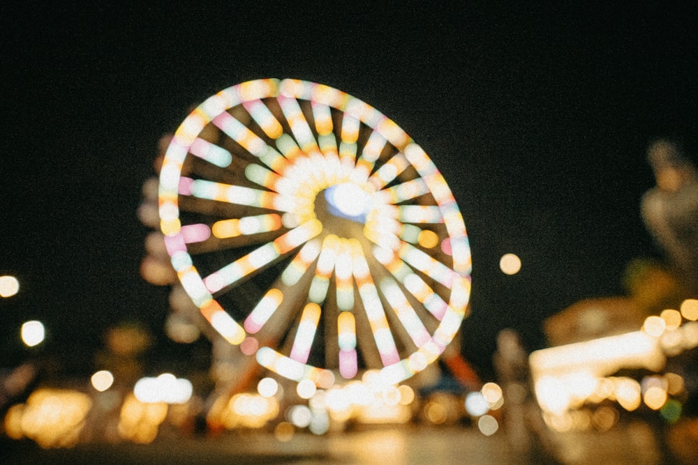 a ferris wheel lit up in the night sky