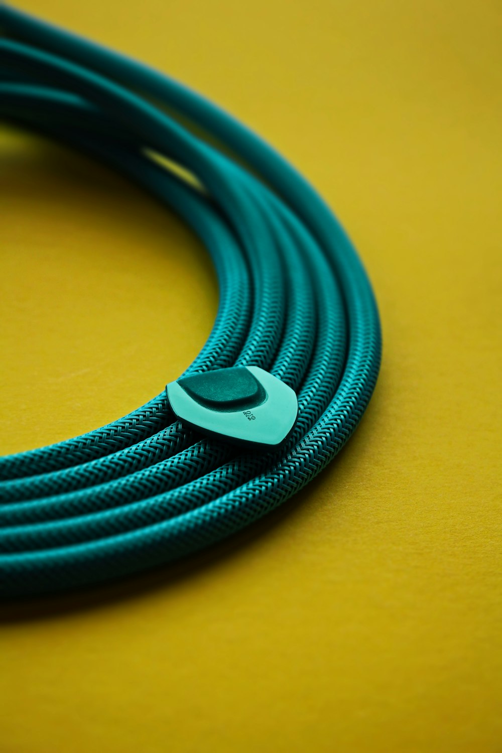 a close up of a blue cable on a yellow surface