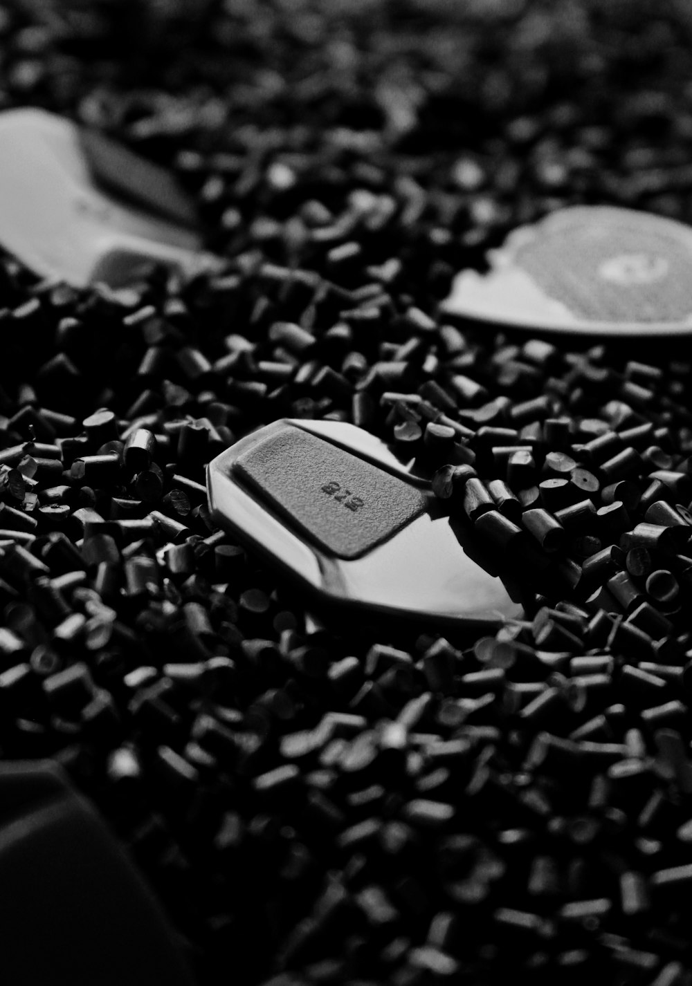 a black and white photo of spoons and a cell phone
