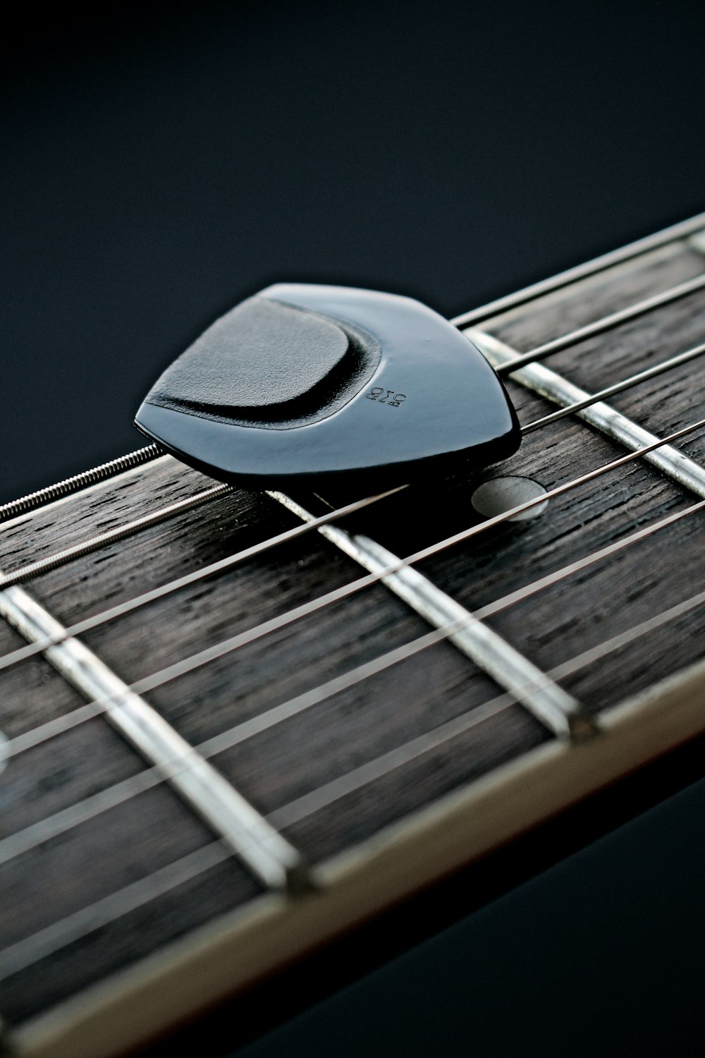 a close up of a guitar pick on a guitar