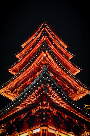 a tall building lit up at night with red lights