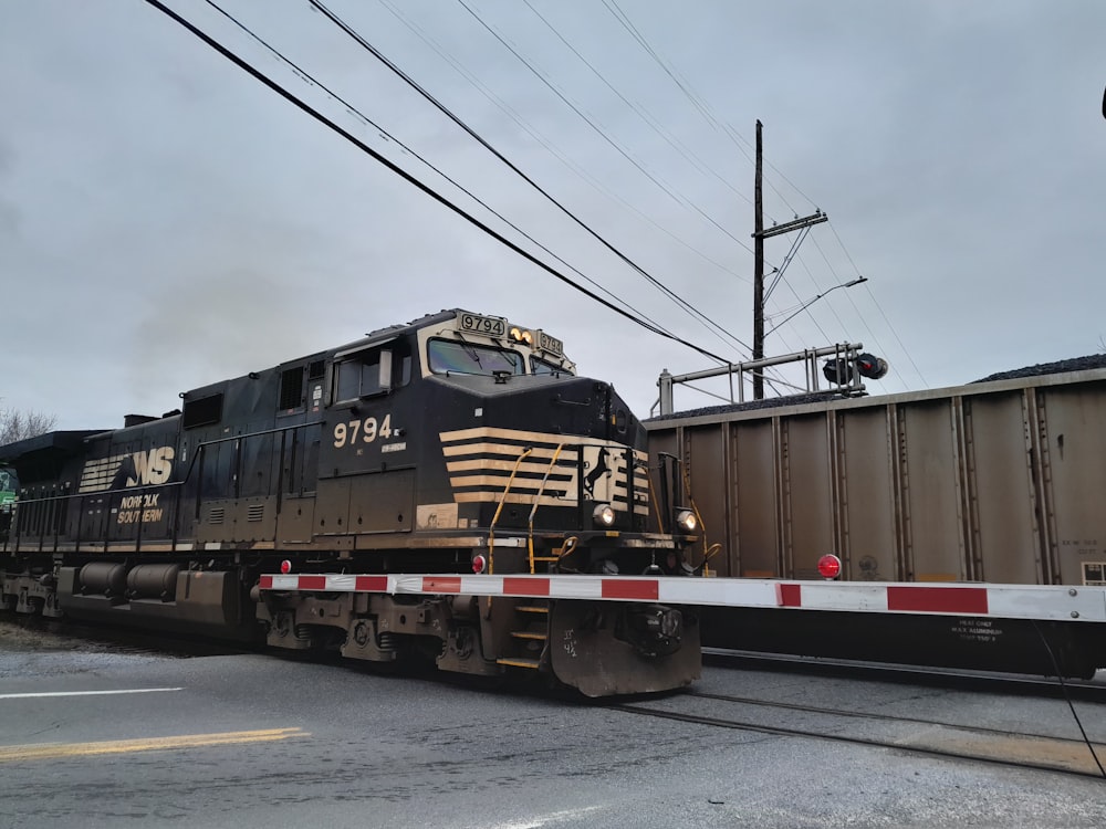 a train traveling down train tracks next to a traffic light