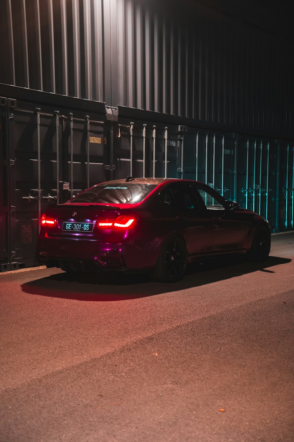 a car parked in front of a building at night