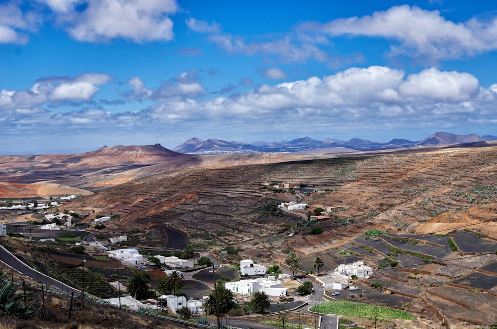 a scenic view of a small town in the mountains