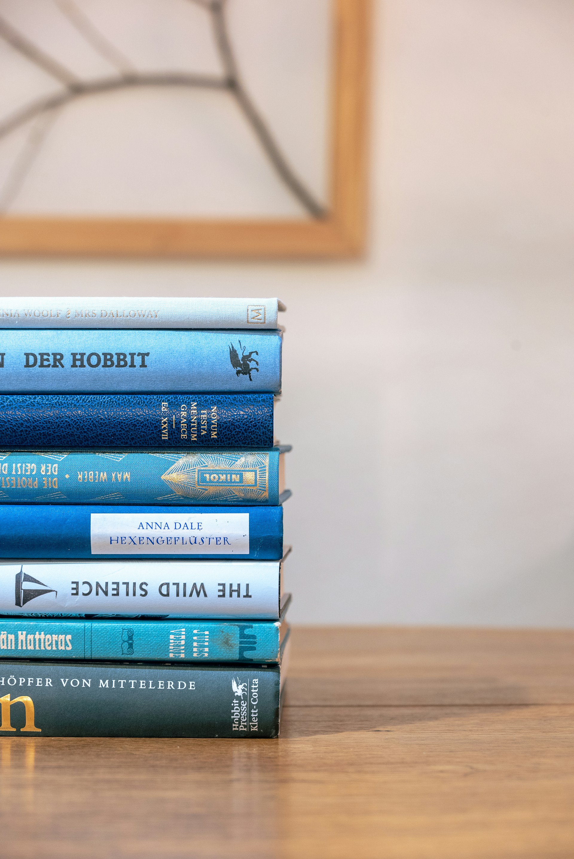 a stack of books sitting on top of a wooden table