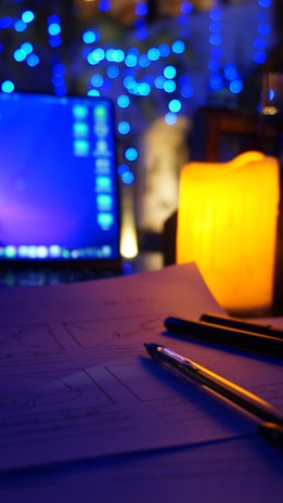 A serene workspace with a laptop open to a guided meditation course, surrounded by crystals and soft candlelight.