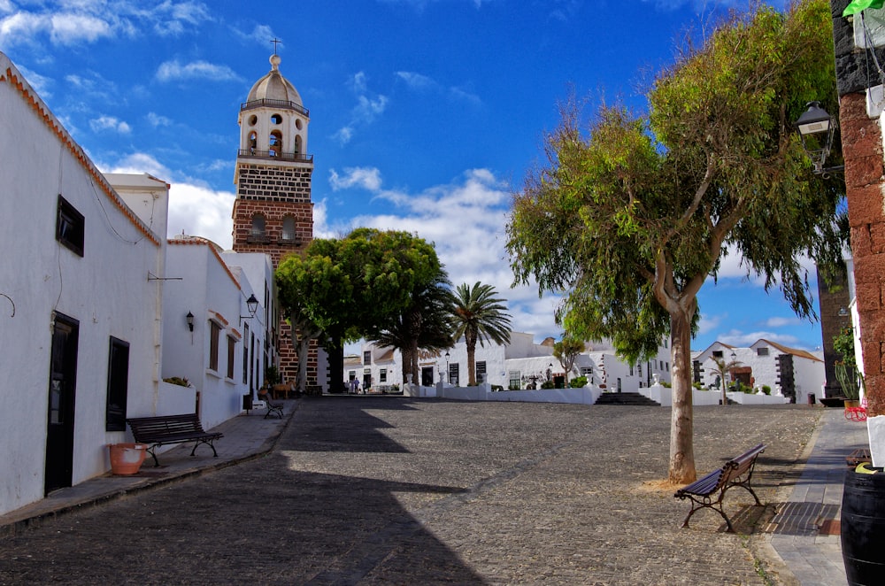 a street with a clock tower in the background