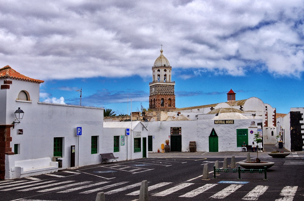 a white building with a clock tower in the background