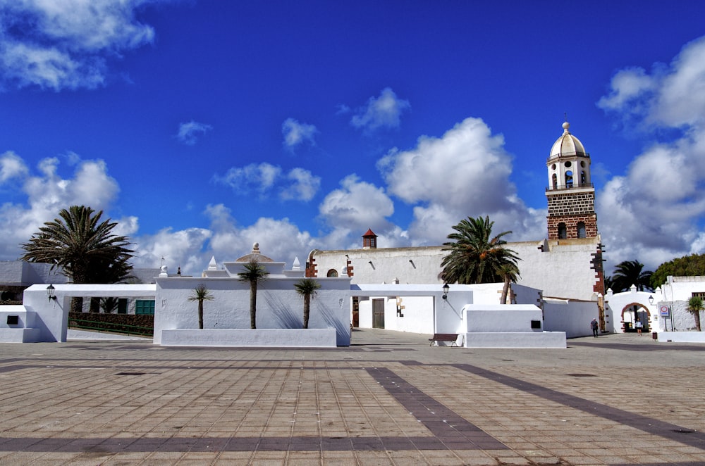 a white building with a clock tower in the background