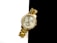 A gold wristwatch with a metallic band and a round face featuring a crystal-studded bezel is positioned against a stark black and white background. The watch face shows three sub-dials and has a sophisticated, luxurious appearance with gold detailing.