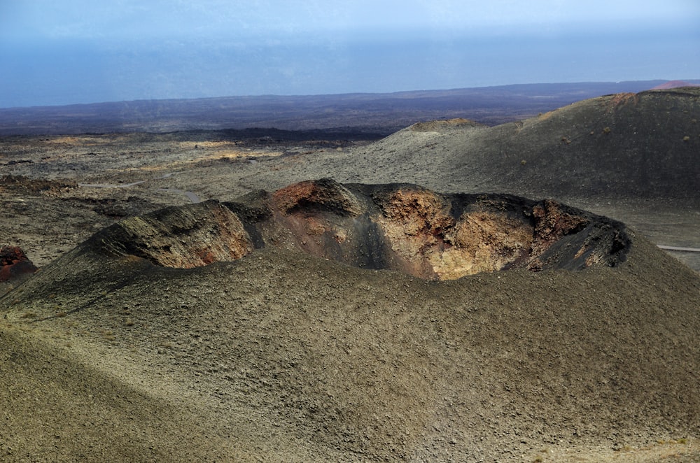 a barren landscape with a road going through it