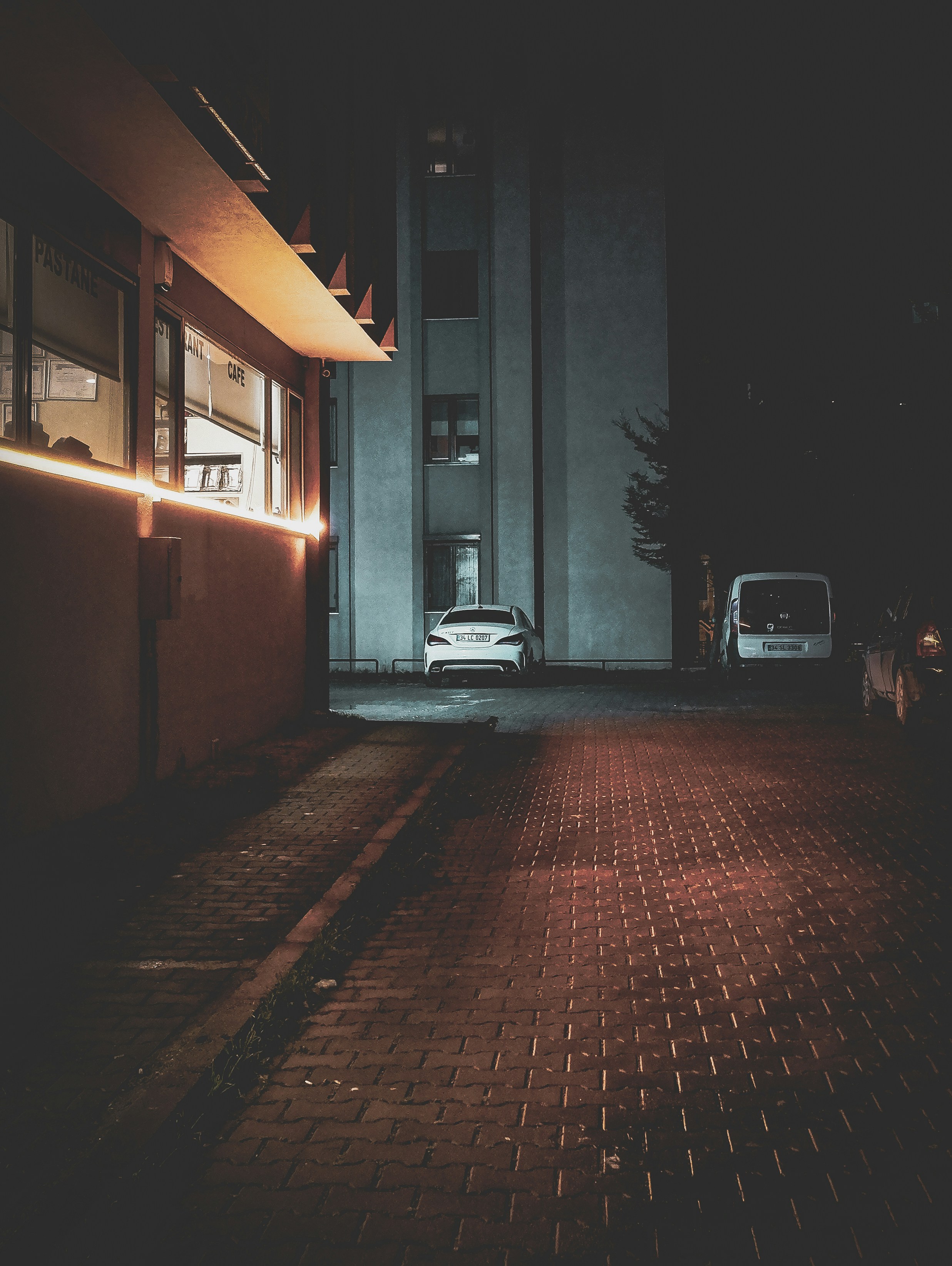 a car parked in front of a building at night