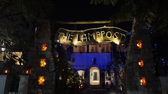 A welcoming office entrance with warm lighting and a sign for lamplighter property group, llc.