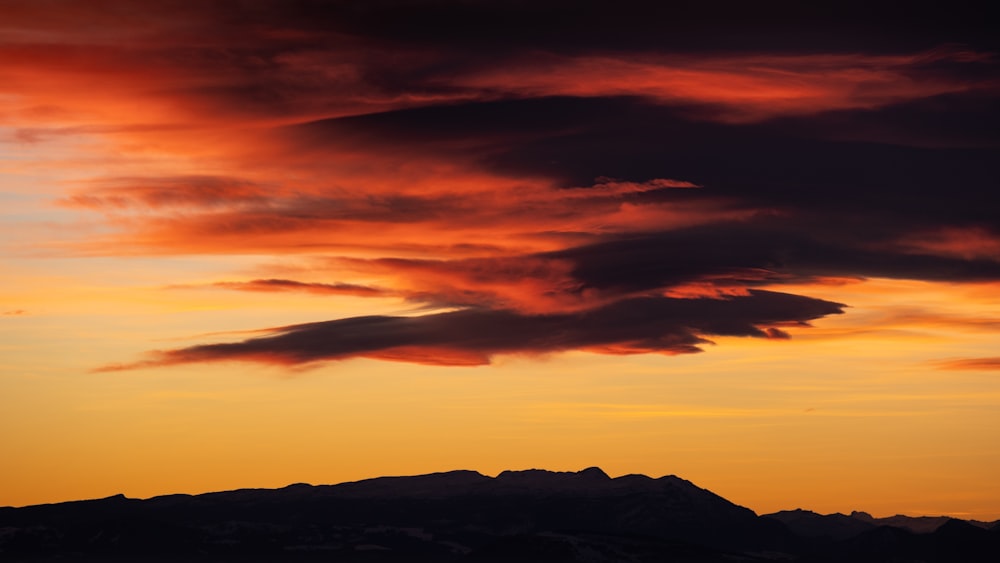 a plane is flying in the sky at sunset