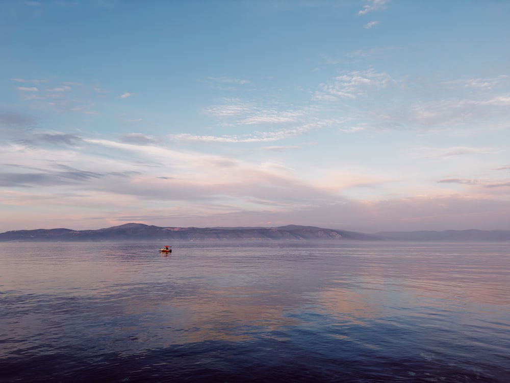 a boat floating on top of a large body of water