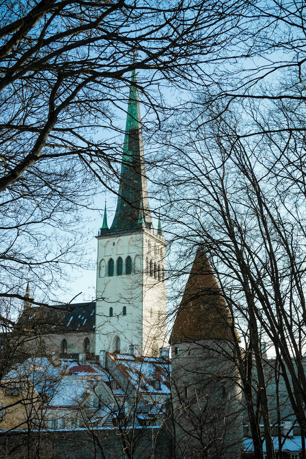 a church with a steeple surrounded by trees