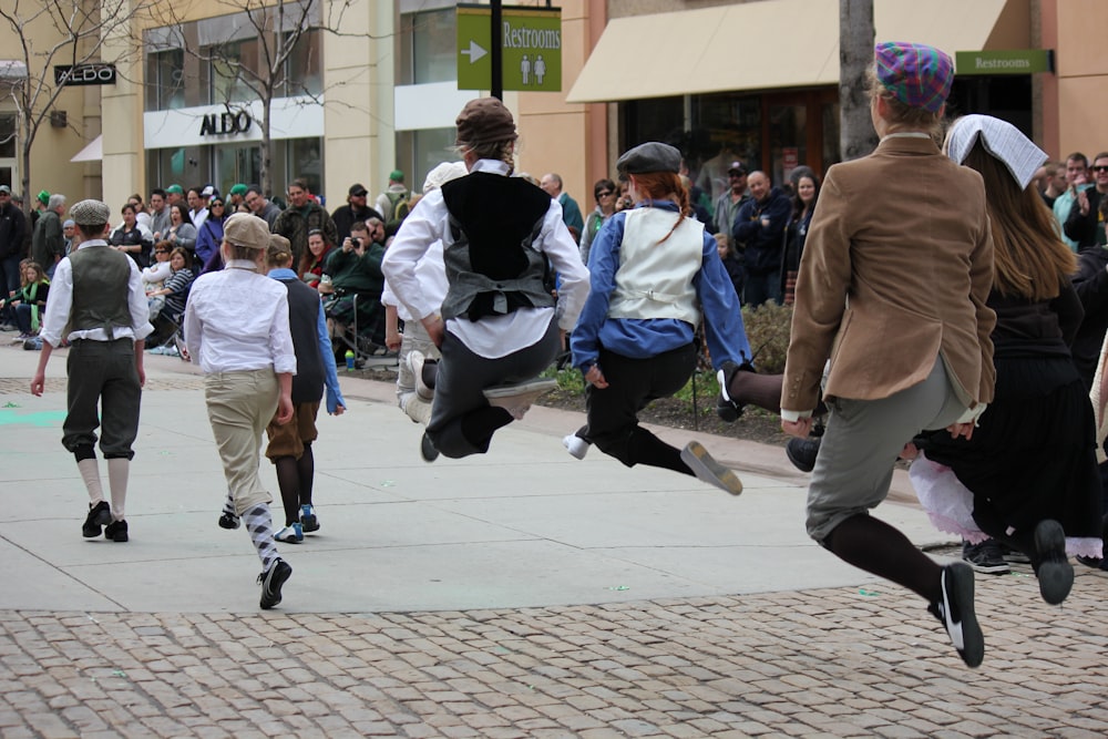 a group of people that are walking down a sidewalk