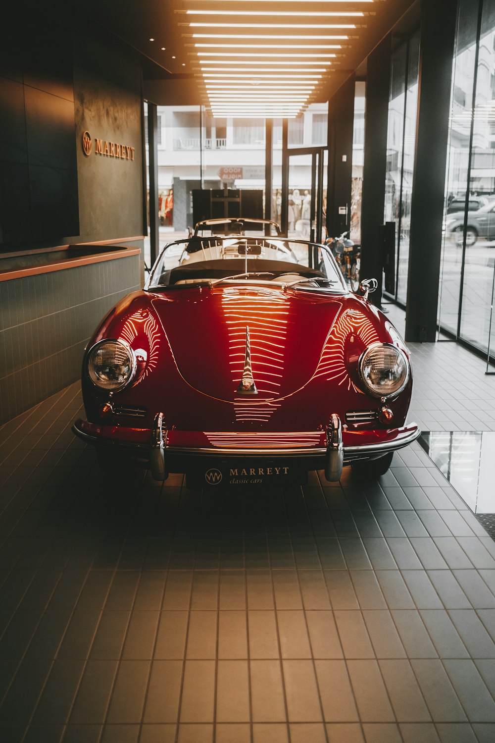 a red car is parked in a building