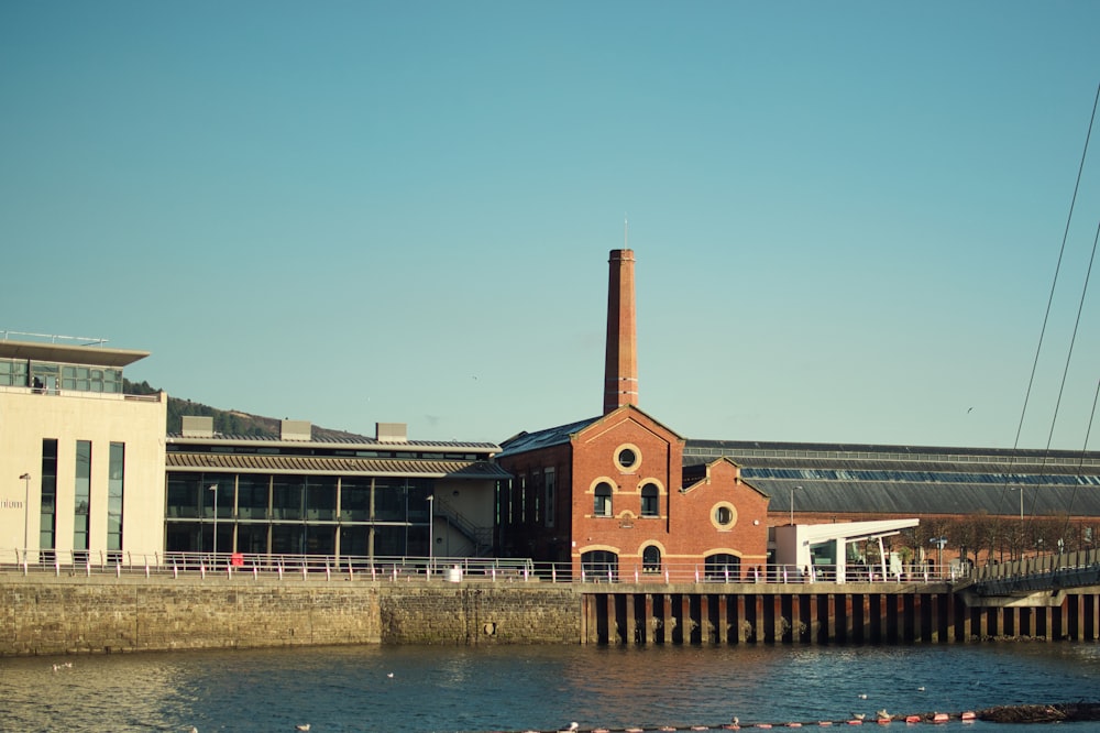 a brick building sitting next to a body of water