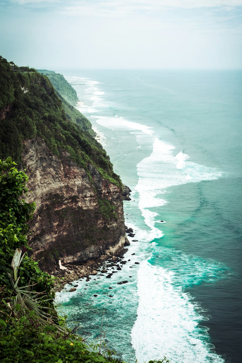 a view of the ocean from the top of a hill