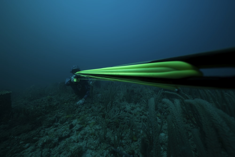 a man in a wet suit is diving in the ocean