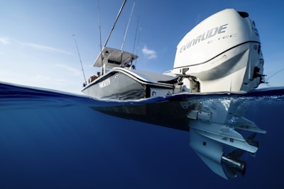 a white boat floating on top of a body of water