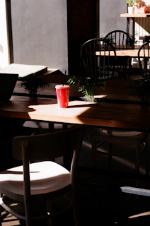 Sunlight streaming through a café window illuminating a Turfscape coffee box and a steaming mug.