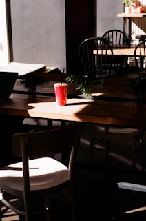 Sunlight streaming through a café window illuminating a Turfscape coffee box and a steaming mug.