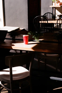 Soft natural light streaming through a café window onto a stylish coffee setup