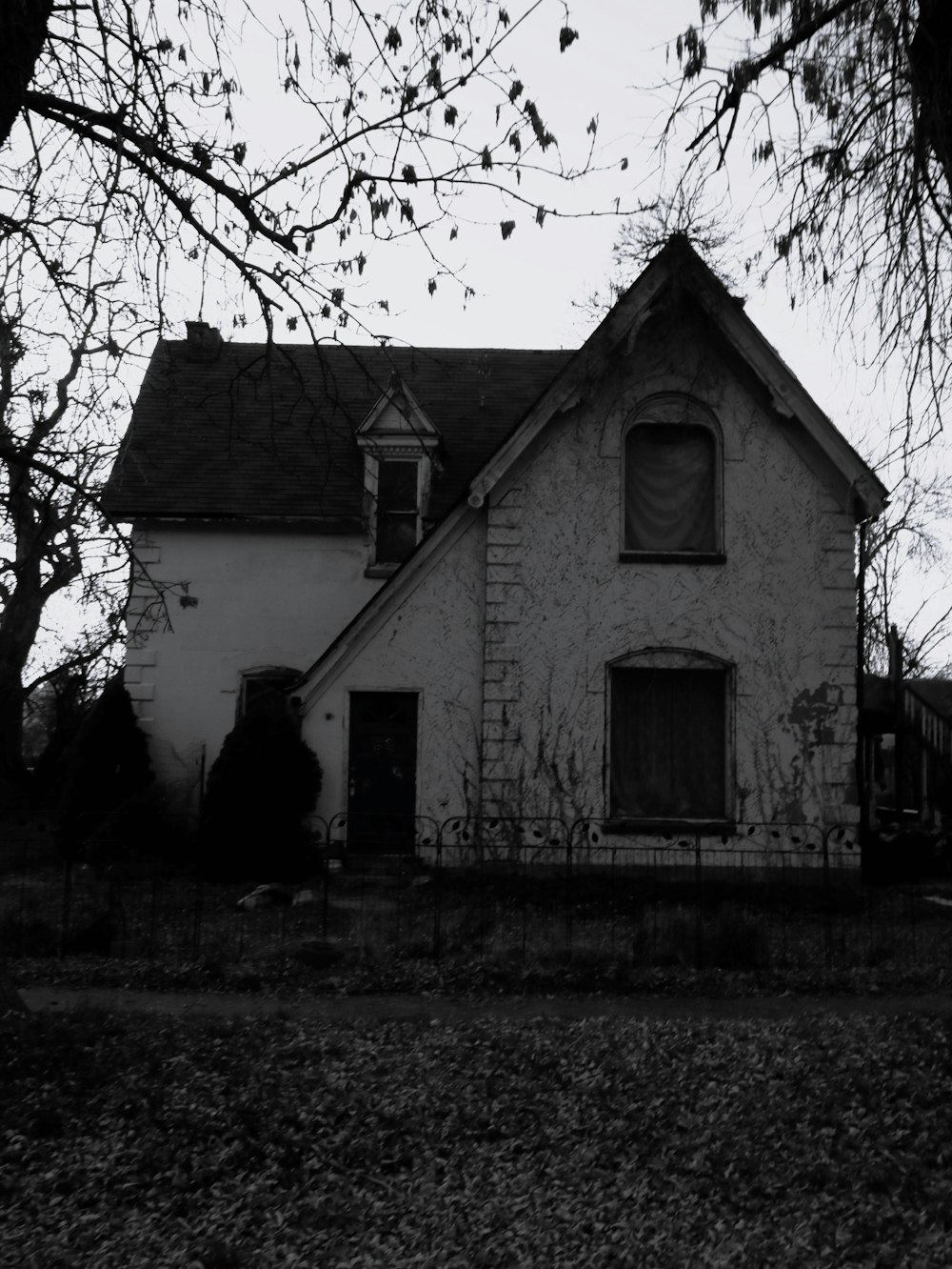 a black and white photo of an old house