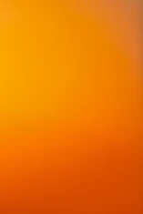 an airplane flying in the sky at sunset