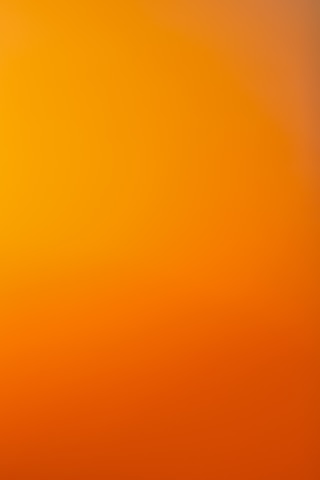 an airplane flying in the sky at sunset
