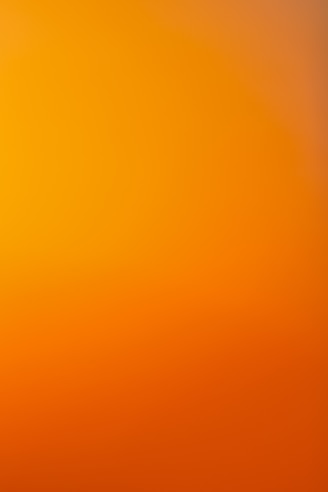 an airplane flying in the sky at sunset