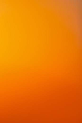 an airplane flying in the sky at sunset