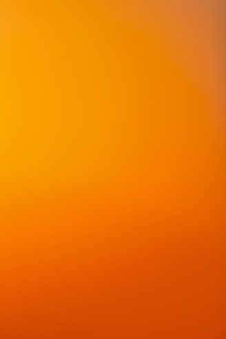 an airplane flying in the sky at sunset