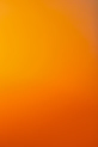 an airplane flying in the sky at sunset