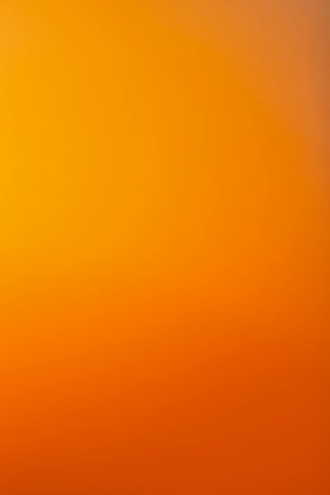 an airplane flying in the sky at sunset